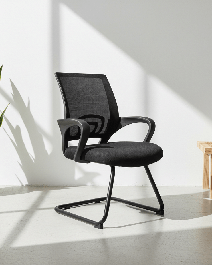 Front view of black fixed visitor chair with breathable mesh back, cushioned seat, fixed armrests and MS cantilever base – Blaze by Kazuri
