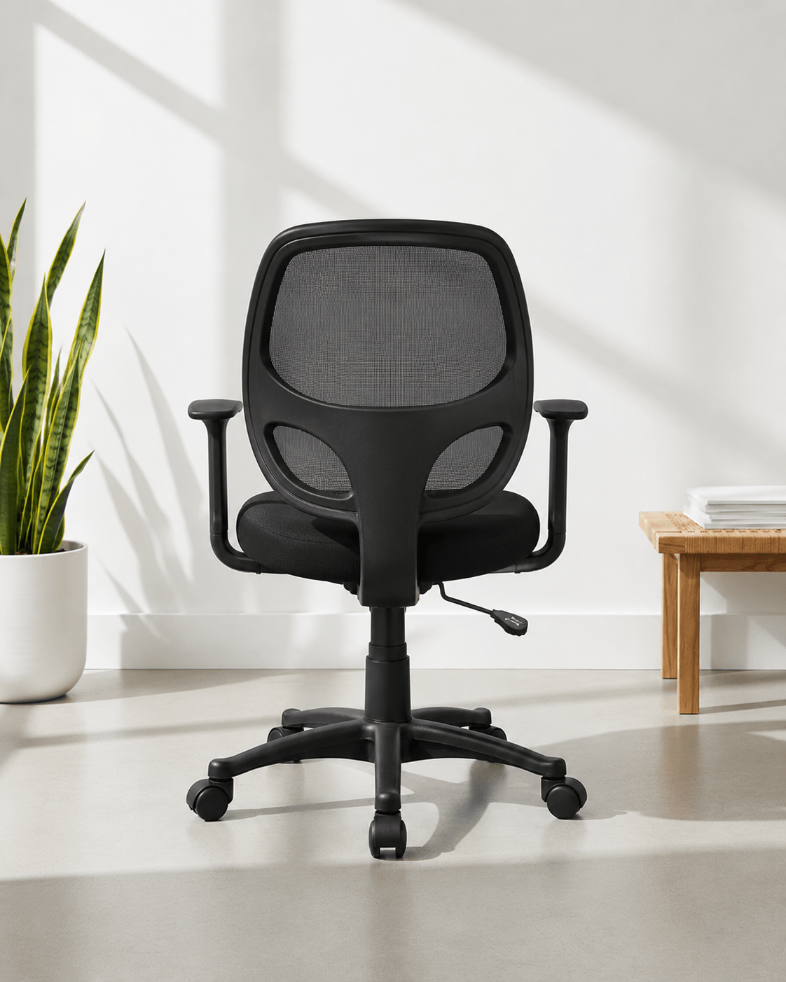 Back view of black mid-back ergonomic office chair with moulded foam seat and back, hydraulic gas lift and nylon swivel base with castors – Beetle MB by Kazuri
