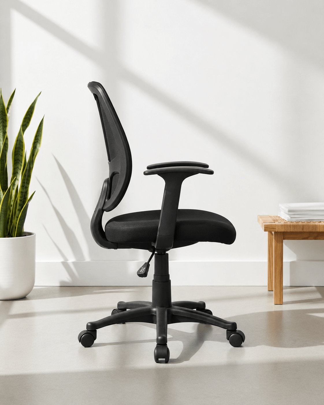 Side view of black mid-back ergonomic office chair with moulded foam seat and back, hydraulic gas lift and nylon swivel base with castors – Beetle MB by Kazuri