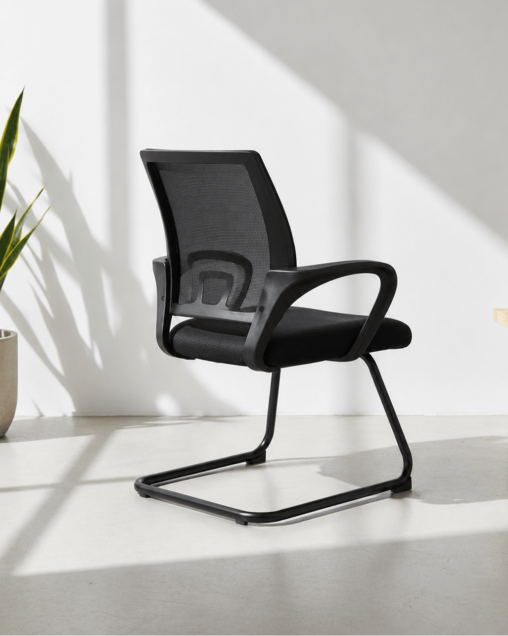 Angled view of Blaze fixed visitor chair showing mesh backrest, cushioned seat and MS cantilever base – Kazuri Store
