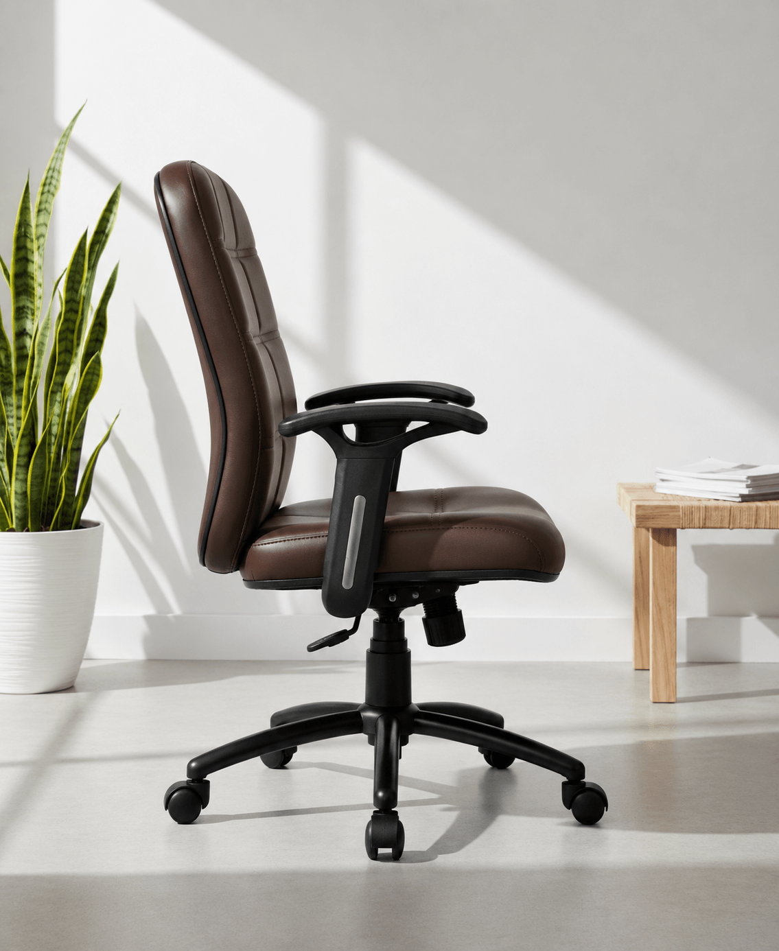 Side view of Checks MB mid-back executive leatherette office chair showing quilted brown back, cushioned seat depth and MS black PC gas lift base – Kazuri Store