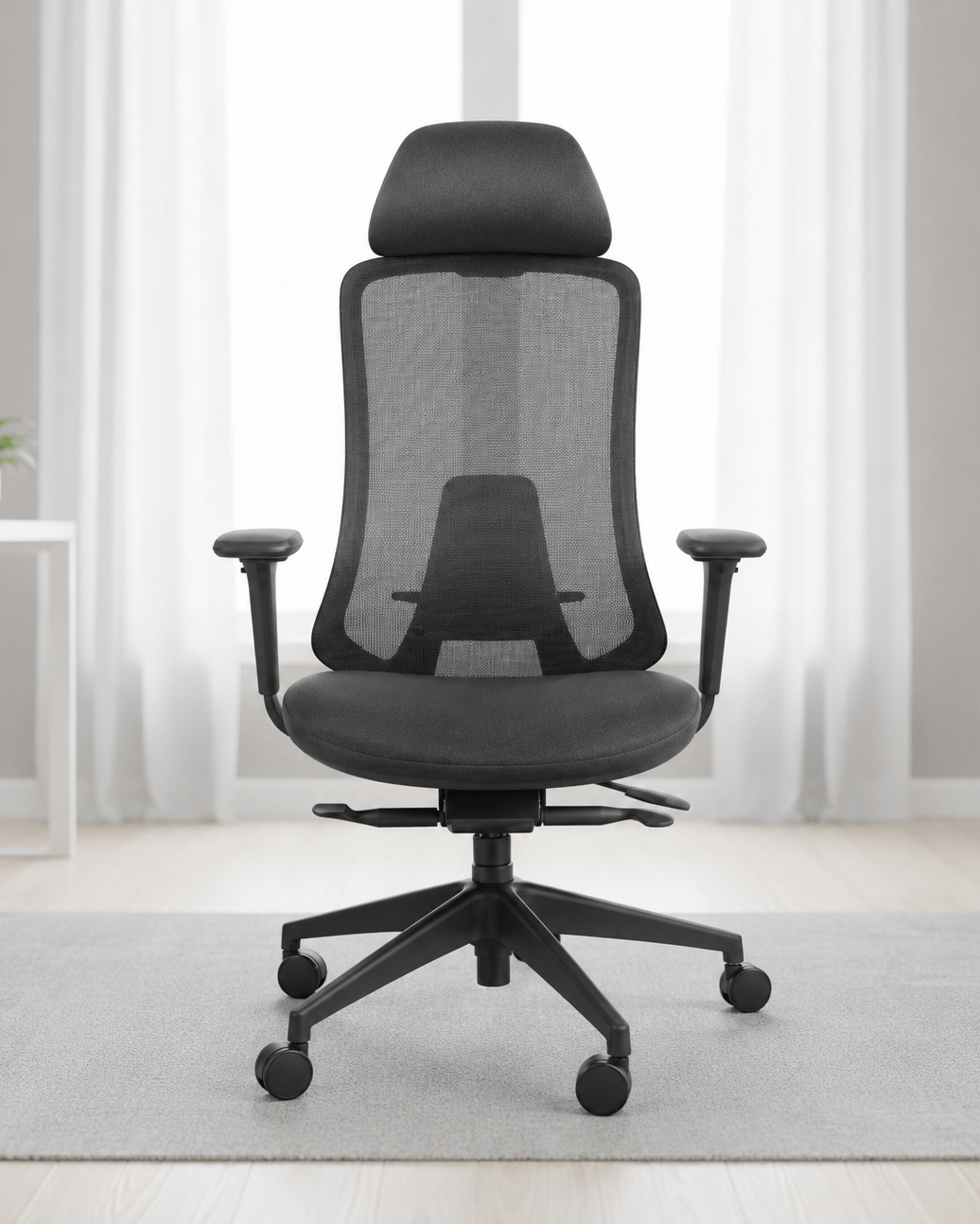 Front view of black high-back ergonomic revolving office chair with moulded foam seat, integrated headrest, adjustable armrests and gas lift base – Fedo HB by Kazuri
