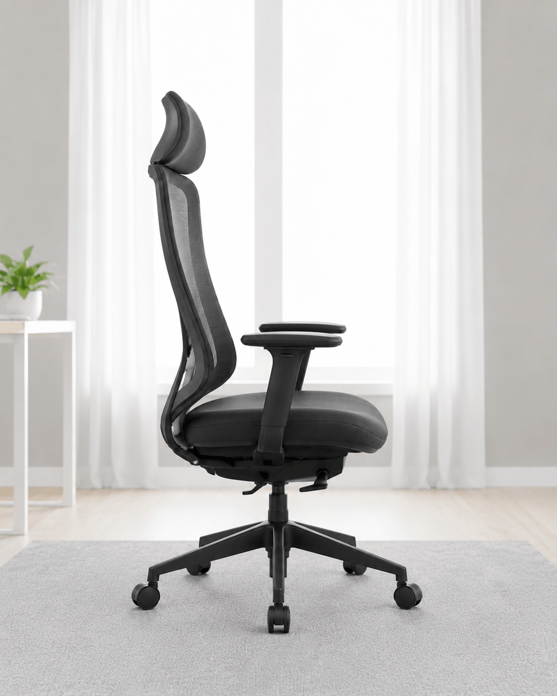 Side view of black high-back ergonomic revolving office chair with moulded foam seat, integrated headrest, adjustable armrests and gas lift base – Fedo HB by Kazuri