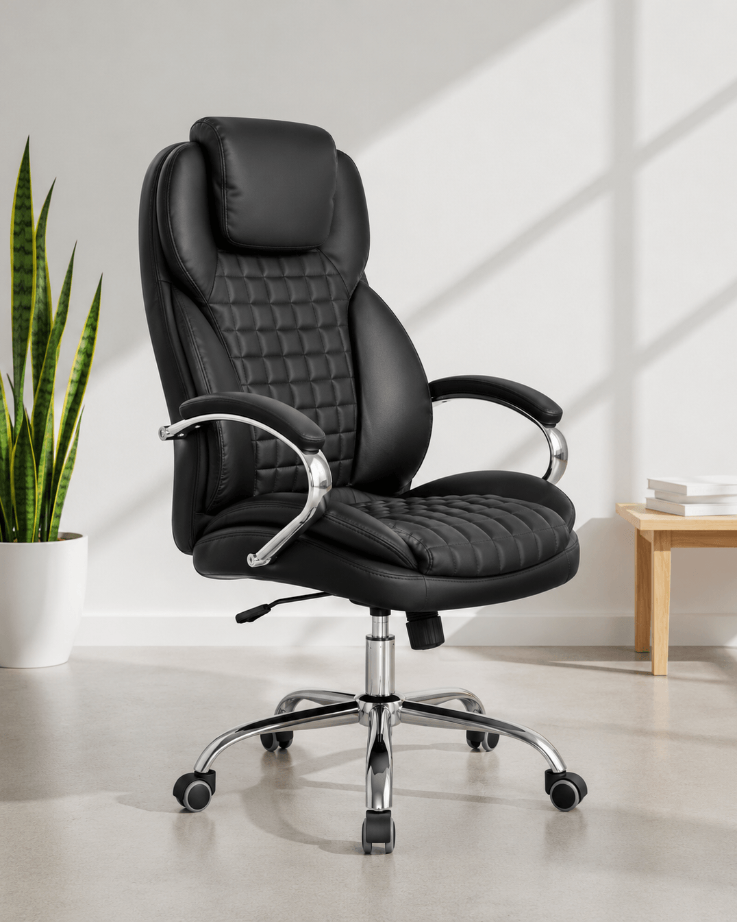 Front view of black high-back executive cushioned revolving office chair with quilted back, integrated headrest, padded chrome armrests and chrome five-star swivel base – Galaxy HB by Kazuri
