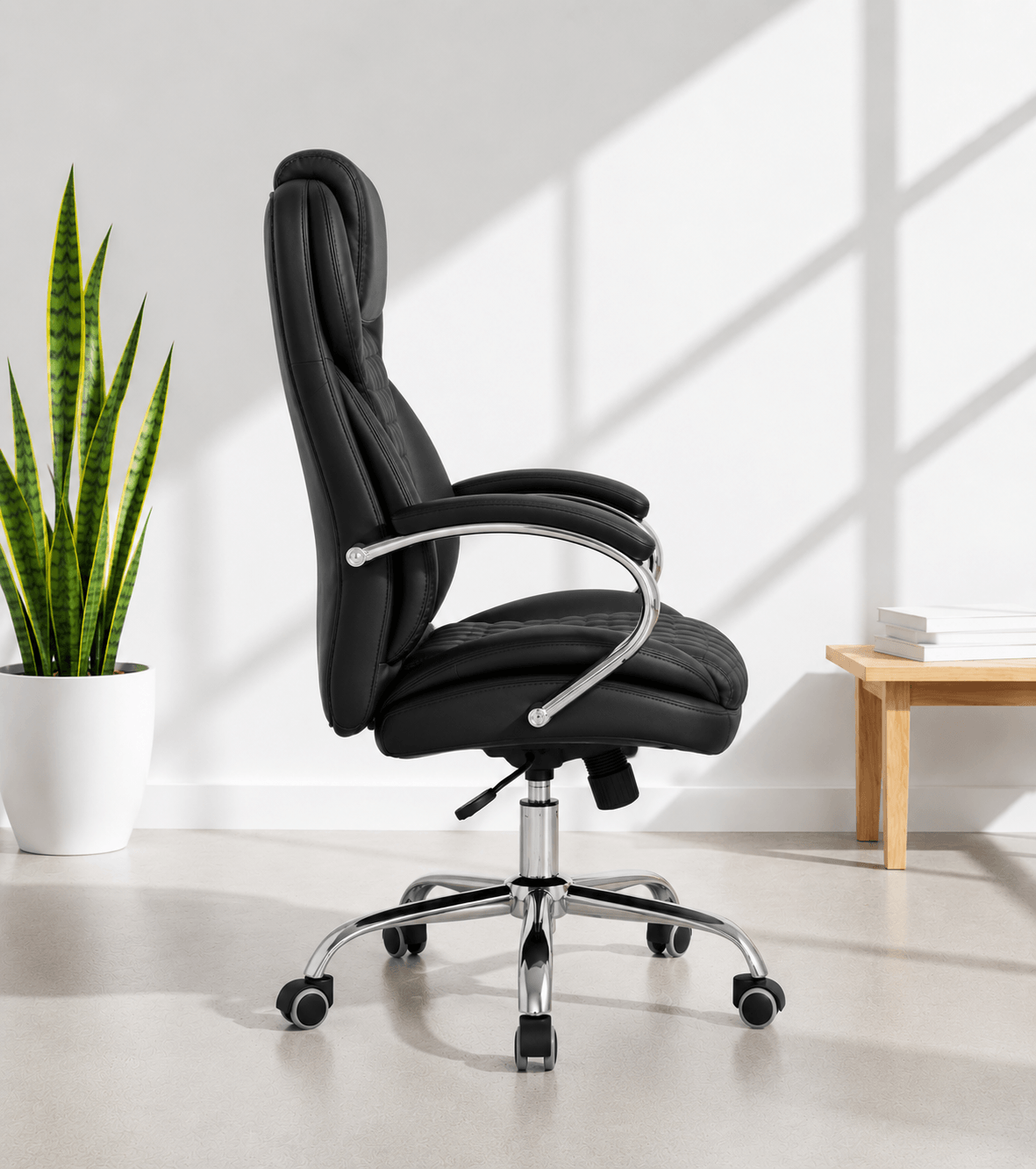 Side of black high-back executive cushioned revolving office chair with quilted back, integrated headrest, padded chrome armrests and chrome five-star swivel base – Galaxy HB by Kazuri