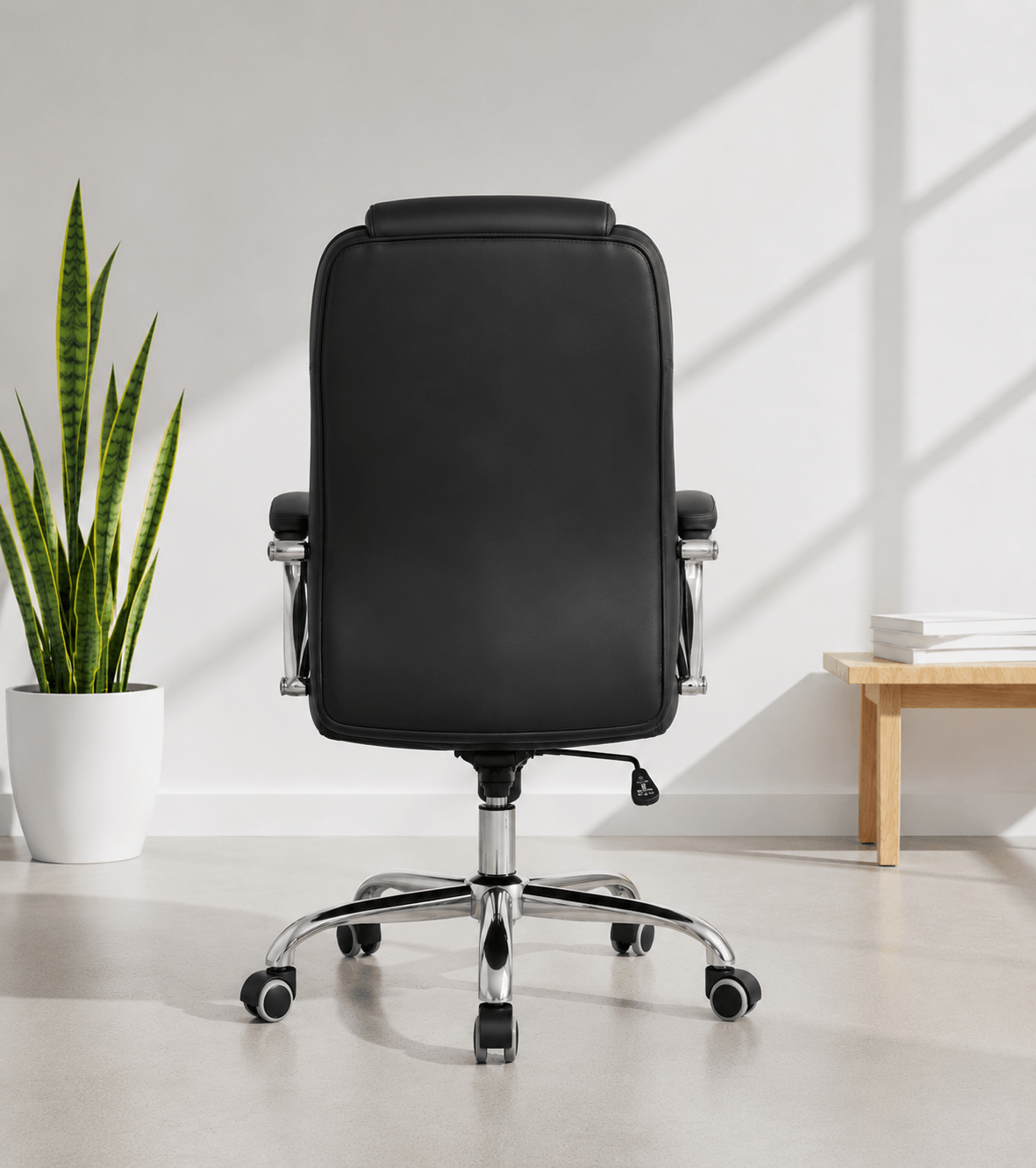 Back view of black mid-back executive cushioned revolving office chair with quilted back, integrated headrest, padded chrome armrests and chrome five-star base – Galaxy by Kazuri