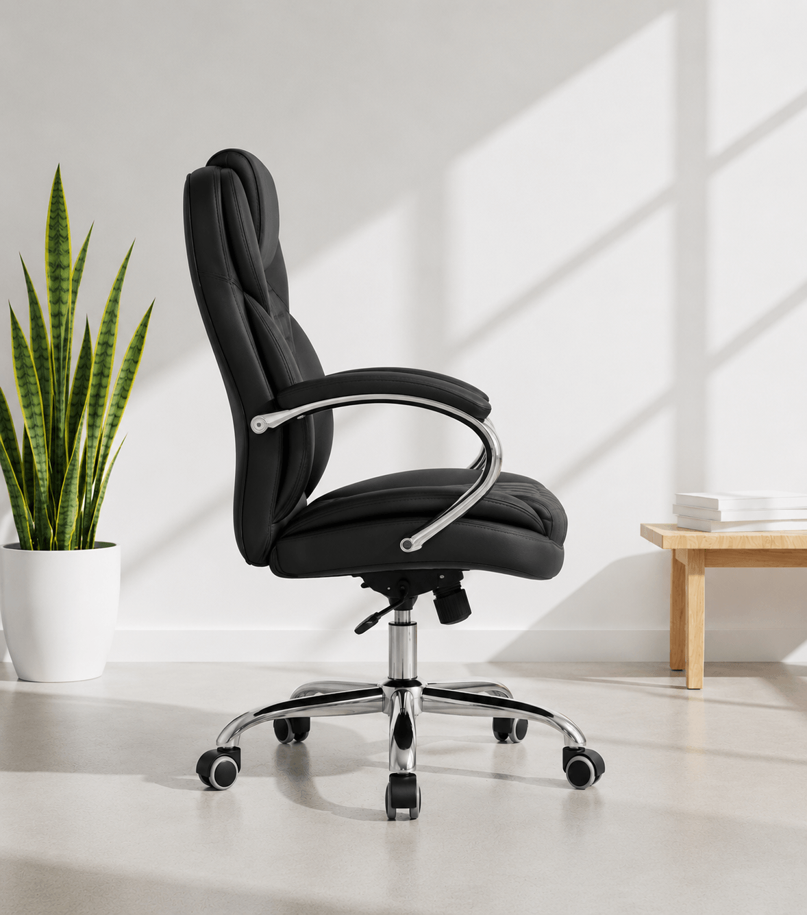 Side view of black mid-back executive cushioned revolving office chair with quilted back, integrated headrest, padded chrome armrests and chrome five-star base – Galaxy by Kazuri