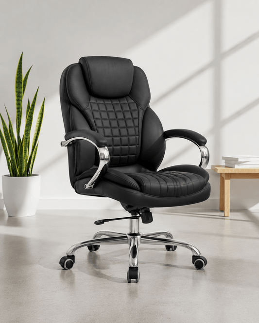 Front view of black mid-back executive cushioned revolving office chair with quilted back, integrated headrest, padded chrome armrests and chrome five-star base – Galaxy by Kazuri