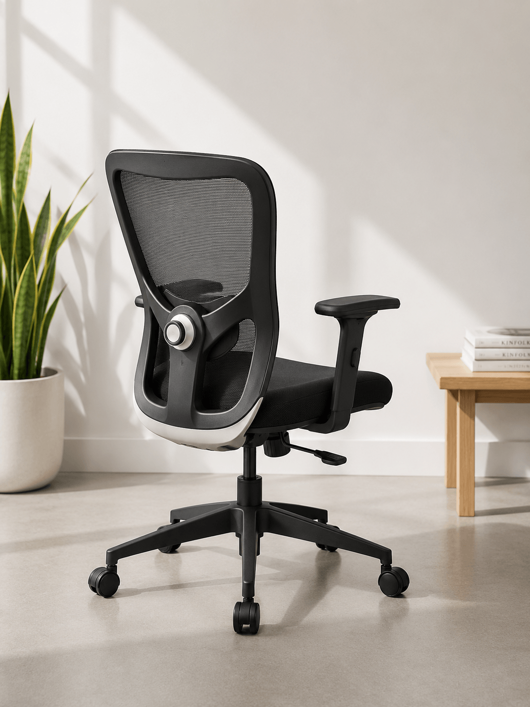 Back view of black mid-back ergonomic mesh revolving office chair with adjustable lumbar support, 2-way armrests and nylon base with castors – Jazz MB by Kazuri