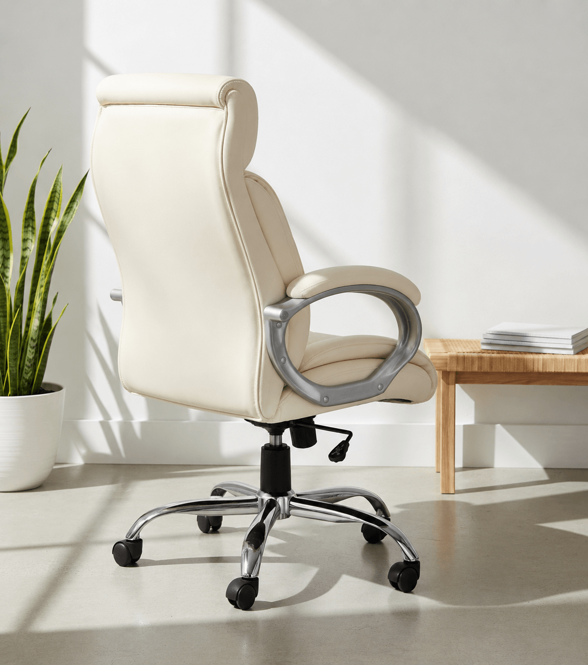 Back view of cream high-back executive cushioned revolving office chair with integrated headrest, padded armrests and chrome five-star swivel base – Tycoon by Kazuri