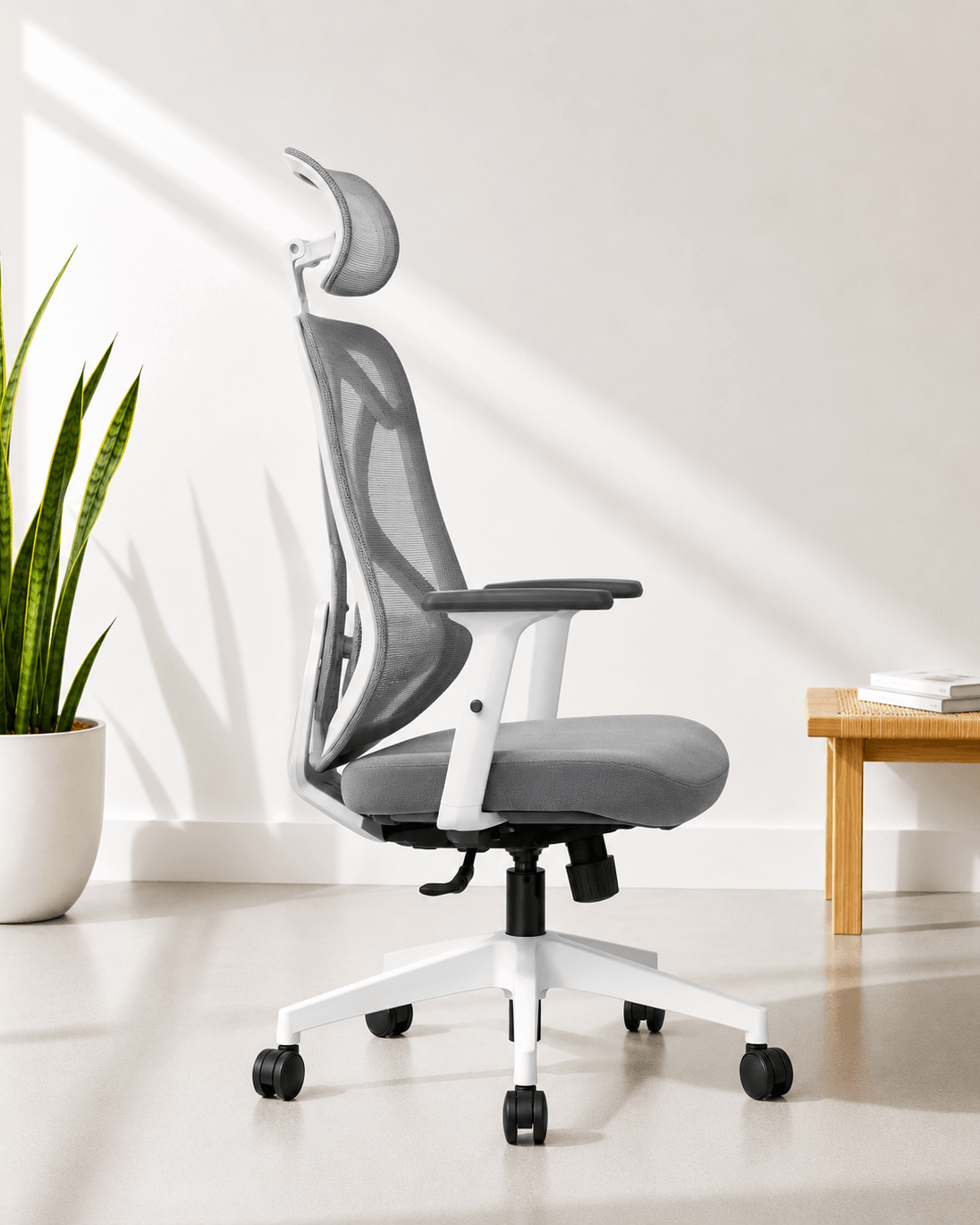 Side view of grey high-back ergonomic mesh revolving office chair with multilock mechanism, adjustable headrest, lumbar support and chrome base – Zen by Kazuri
